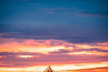 Very beautiful landscape of the evening sky with clouds, sunset. Blue, orange sky.