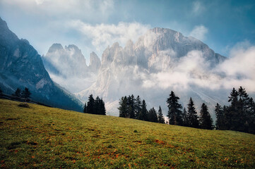 beautiful mountain landscape in the morning with fog, clouds and sun rays