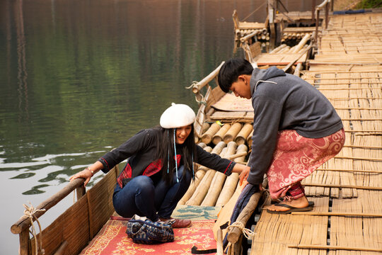 Travelers thai women journey travel visit and take photo between on bamboo rafting tour at Pang Ung lake in Pang Oung forest park at Ban Rak Thai on February 28, 2020 in Mae Hong Son, Thailand