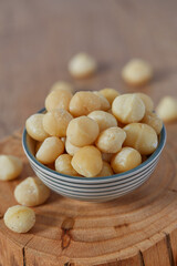 macadamian nuts on dark wooden surface