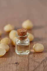 macadamian nut oil on dark wooden surface