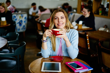 Smiling woman with cup of coffee