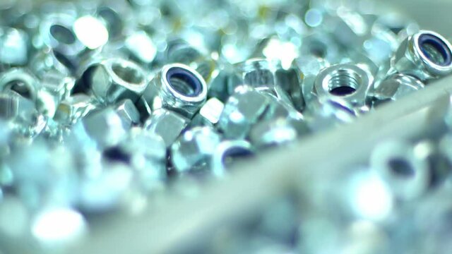 The boxes filled with bolts, nuts aand screws. Close up shot in automotive parts factory warehouse. raw materils depot.