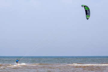 Kite surfer at sea near the beach of Noordwijk.