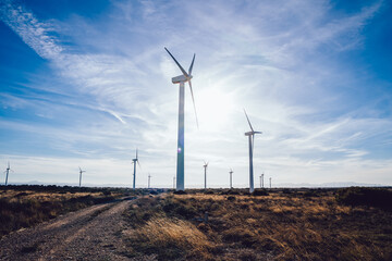 Wind turbines against partly cloudy sky