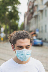 Young man wearing mask in the city streets