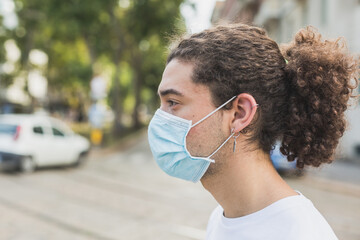 Young man wearing mask in the city streets