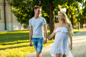 Fototapeta premium pregnant woman with her husband walking in a park