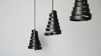 A modern loft chandeliers made of black metal spiral in a stylish white interior
