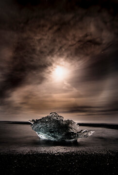 ceberg in iceland on the beach with full moon