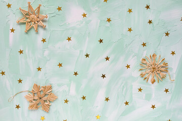 Christmas decoration - diy snowflakes and golden foil stars on green and white backround. Winter holidays concept. Flat lay, copy space, top view, social media hero header template.