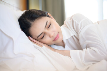 Young beautiful woman sleeping in her bed at home