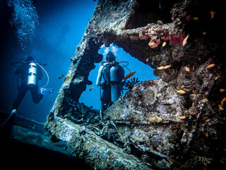 A retiring photographer and a lone model after completing an underwater photo session on a sunken...