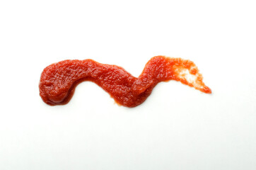 Closeup of smear of tomato sauce on the white background
