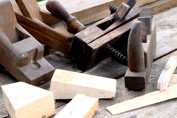 Old wooden carpenter's planes on a wooden background. Still life with old carpenter's planes