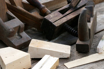 Old wooden carpenter's planes on a wooden background. Still life with old carpenter's planes