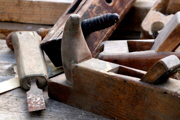 Old wooden carpenter's planes on a wooden background. Still life with old carpenter's planes