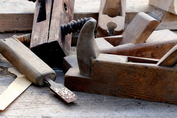 Old wooden carpenter's planes on a wooden background. Still life with old carpenter's planes