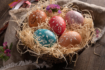 Colorful Easter eggs decorated with wax on a table