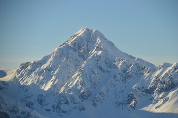 Fototapeta na wymiar Skiing in the snow covered mountains of the San Domenico Ski Resort in Alps in Northern Italy