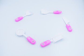 Children's pink plastic cooker for cooking on a white background