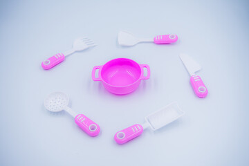 Children's pink plastic cooker for cooking on a white background