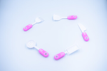 Children's pink plastic cooker for cooking on a white background