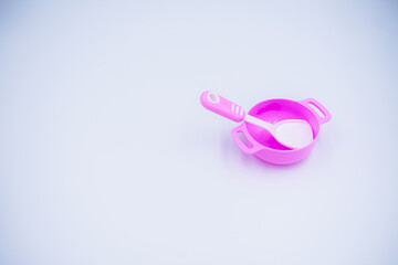 Children's pink plastic cooker for cooking on a white background