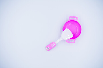 Children's pink plastic cooker for cooking on a white background