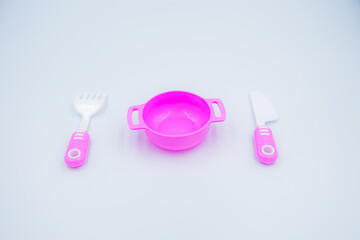 Children's pink plastic cooker for cooking on a white background