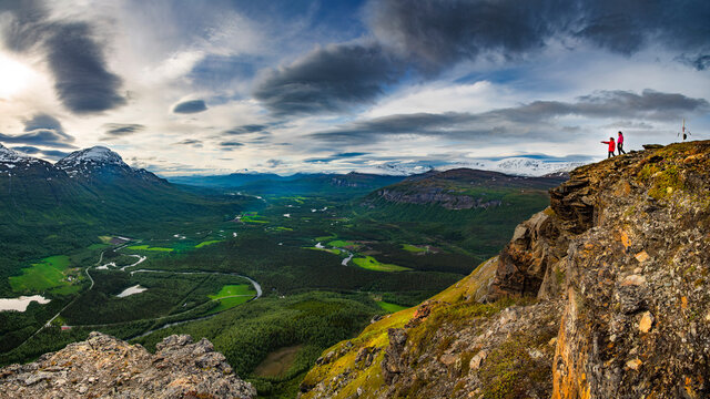Two girls gazinng over a great valley in the Bardu district in northern Norway