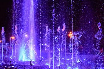 Colorful musical fountain at night. Fountain of frozen splashes. Chelyabinsk, Russia, 05 September 2020. blurred image, colored bokeh.