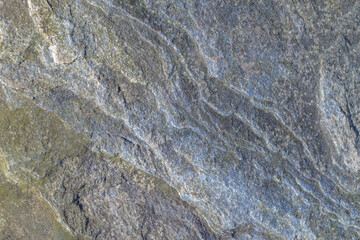 Top view. Rough, uneven, irregular granite stone surface. Natural textured relief grey background.