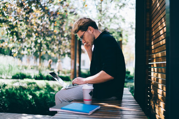 Freelancer checking data on laptop during phone call