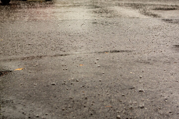 flooded road during heavy rain. raindrops splashes background.