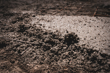 Mixed wet cement solution used for floor or sidewalk renovation, concrete casting and reinforcing metal bars on construction site