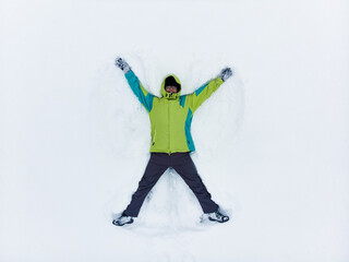 overhead view of man making snow angel