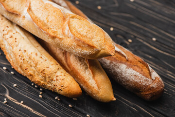 fresh baked baguette loaves on wooden surface