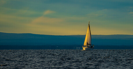 setting sun lights up the sails of  schooner on Lake Champlain, Burlington, Vermont
