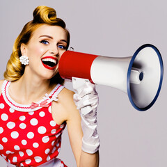 Blond woman holding megaphone, shout something. Girl in pin-up style dress in polka dot, isolated over grey background. Caucasian model posing in retro fashion vintage studio concept. Square.