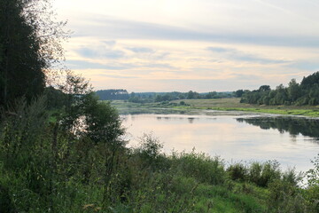View of the river in the countryside at sunset