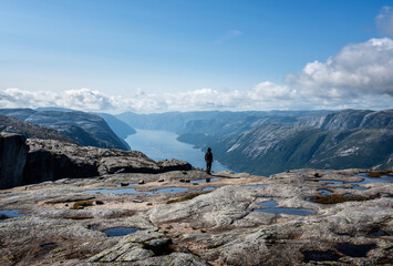 Man gazing at a wonderfull fjord landscape at Lysefjorden