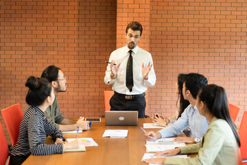 Asian teamwork business people working in modern office .Group of man and woman focus to the...