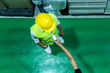 The worker getting his temperature measured with infrared thermometer during coronavirus outbreak....