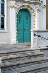 Fototapeta na wymiar Building entrance with old stone stairs