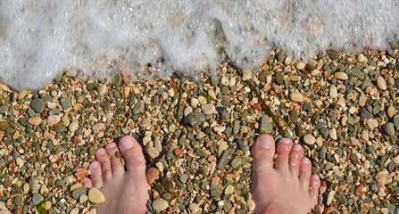 feet on the shingle on the seashore antistress