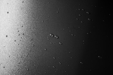 Water drops on plastic black surface as texture