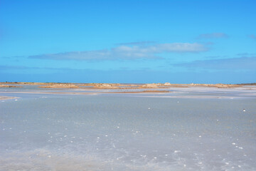 The blue and white colours of the Porto Ingles salt pans in a sunny day