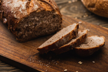 cut fresh baked bread on wooden cutting board