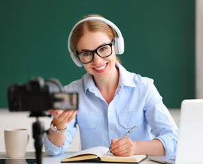 Delighted teacher recording online lesson.